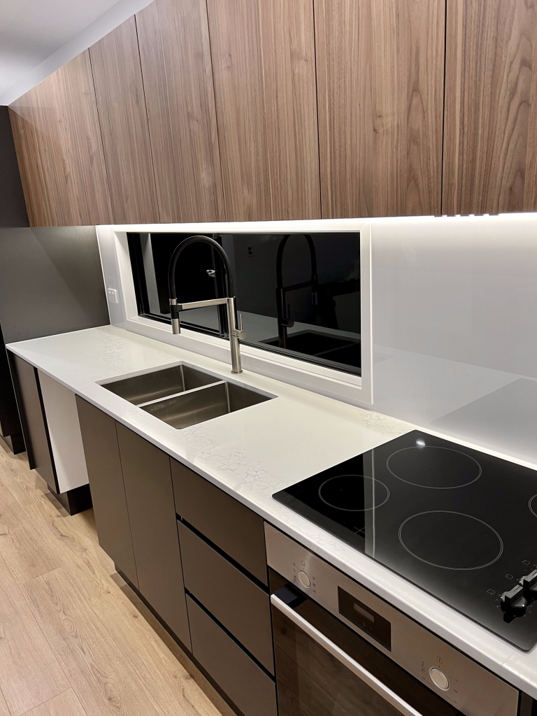 HOMElife Pods interior kitchen design with quantum quartz engineered stone and highgrove spin mixer brass tap and electric cooktop ceramic bosch